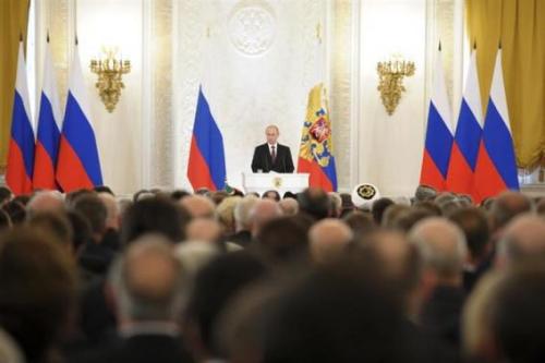 "Russian President Vladimir Putin (back) addresses the Federal Assembly, including State Duma deputies, members of the Federation Council, regional governors and civil society representatives, at the Kremlin in Moscow" (Reuters/Alexei Druzhinin/RIA Novosti/Kremlin)